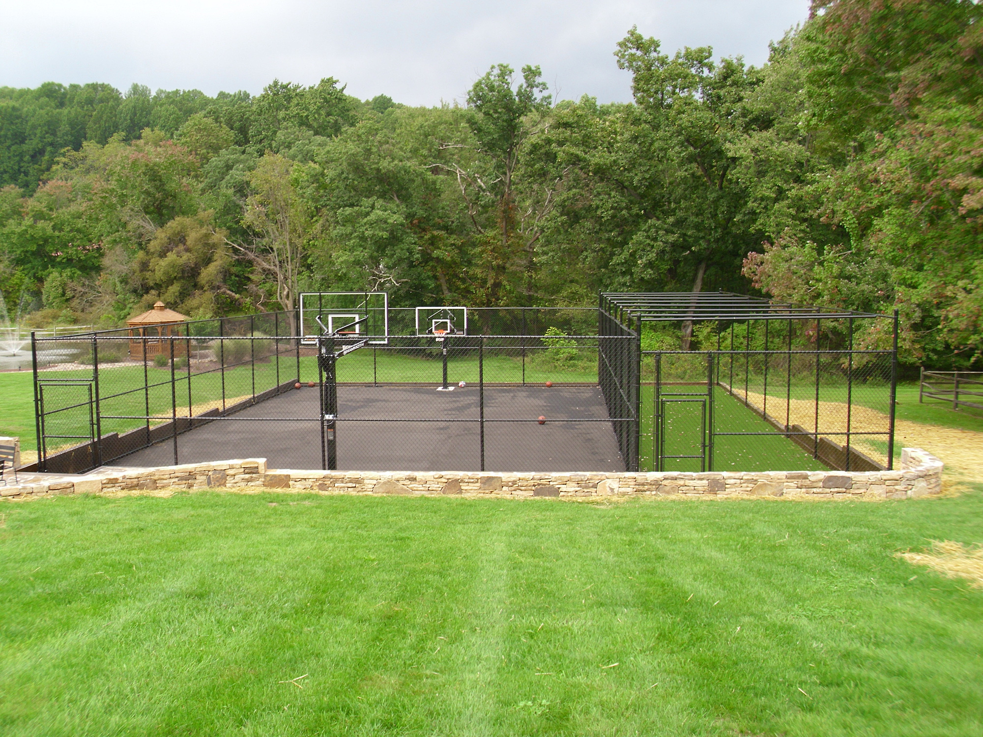 Chain link fence around sports court at a residence