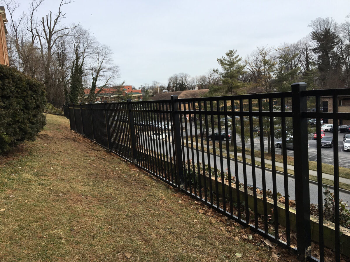 decorative black aluminum security fence above wall