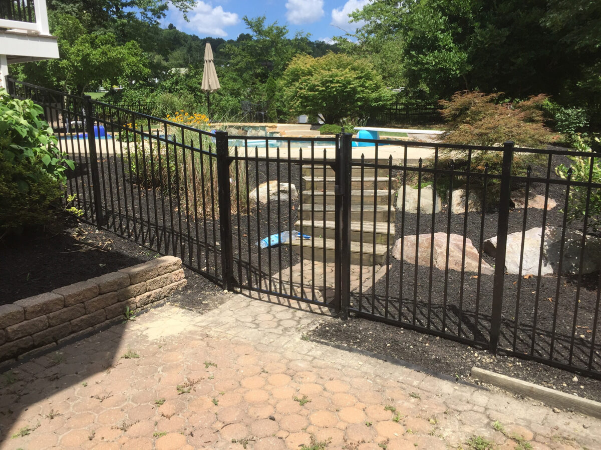 black ornamental fence around pool with gate