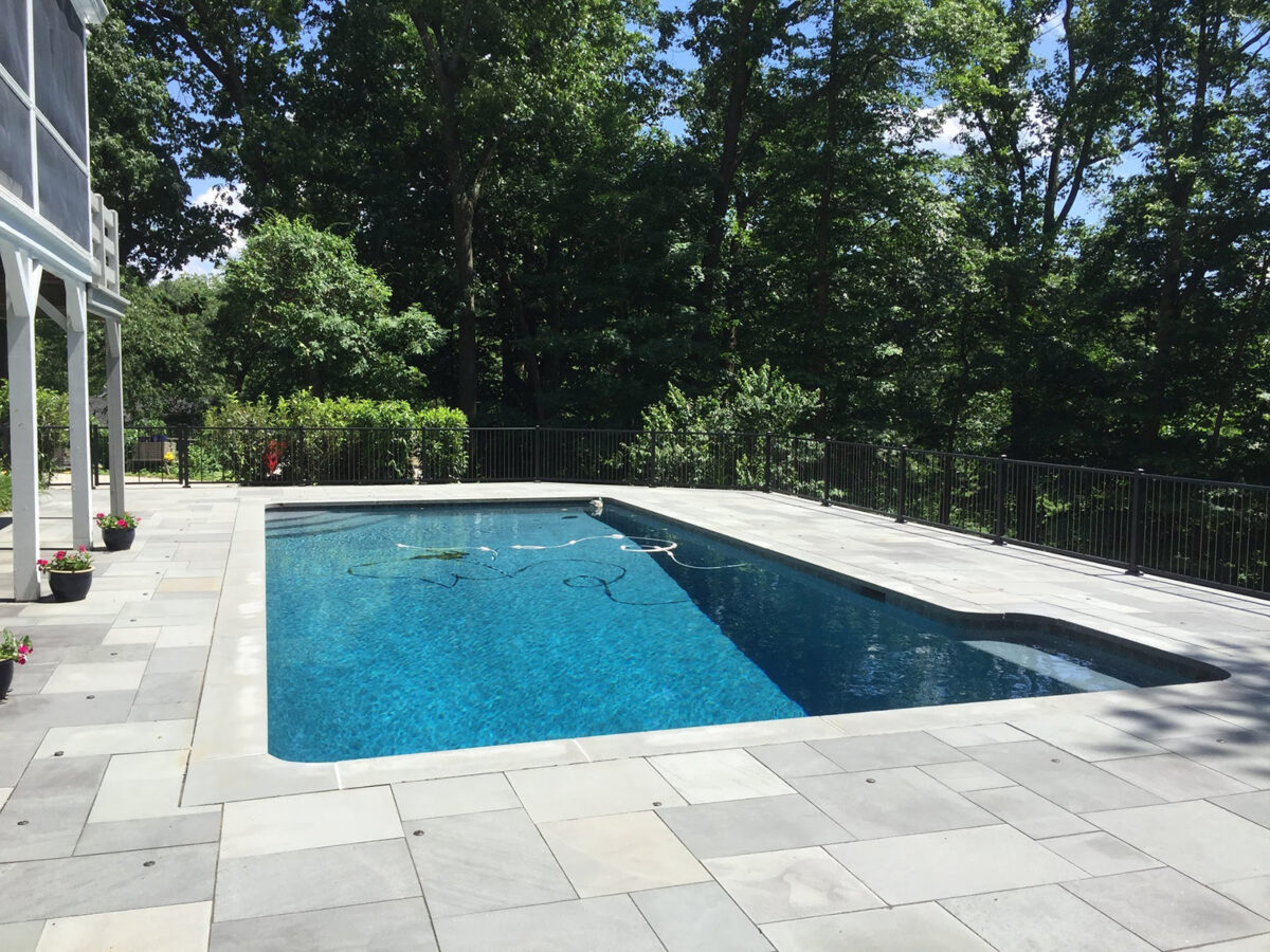 black ornamental fence around pool with cables