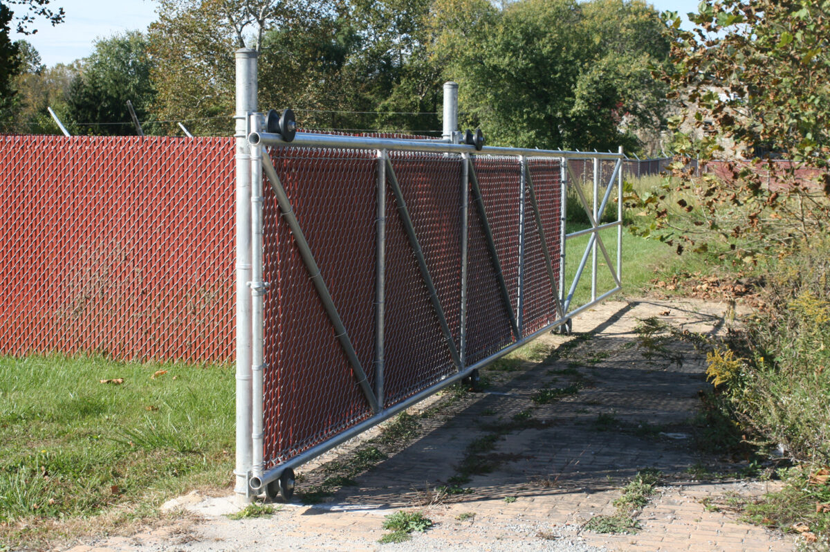 Chain link fence with sliding gate and privacy slats