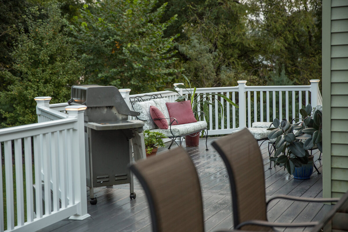 deck with vinyl railing and lighted post caps