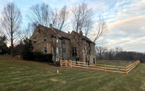 split rail fence with wire mesh in yard