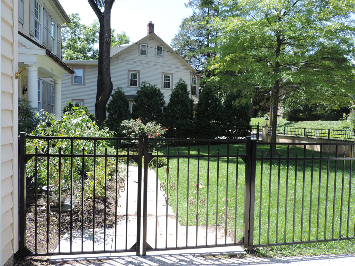 Ornamental aluminum fence with double gate in yard