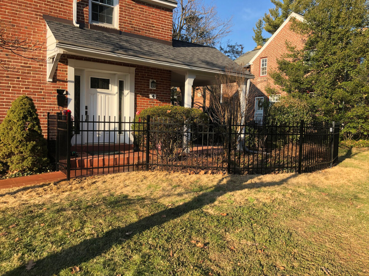 Ornamental aluminum fence with gate in yard