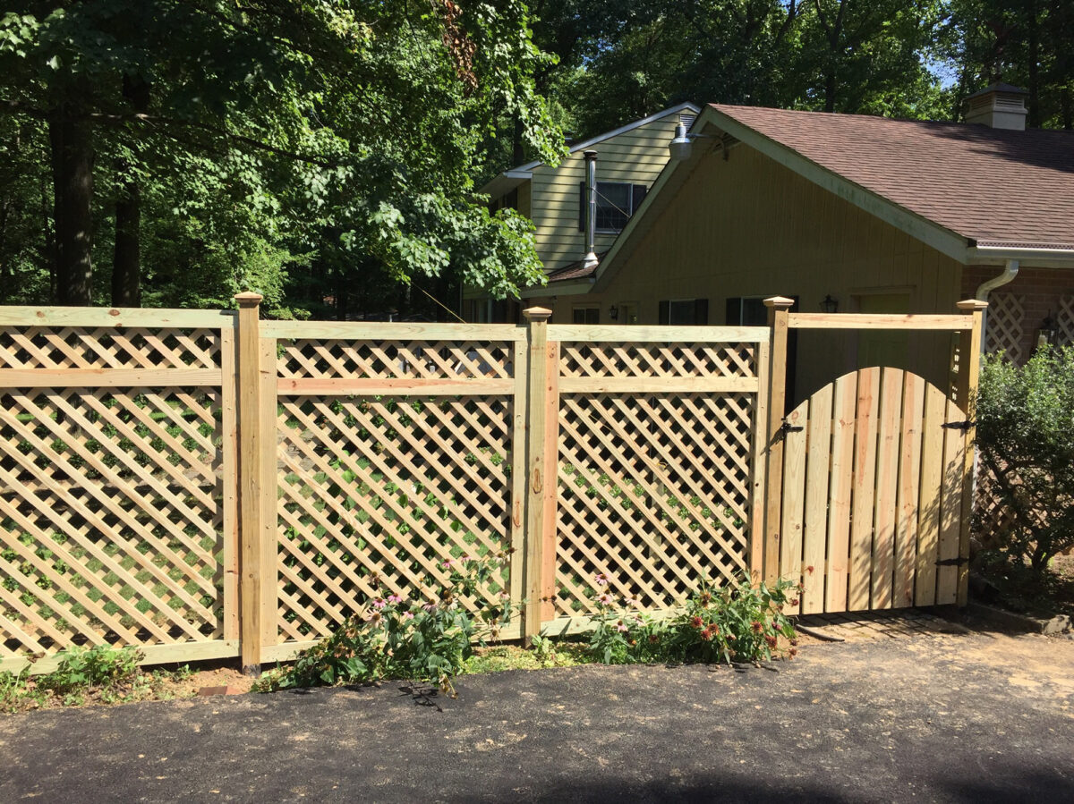 wood lattice fence with arched gate