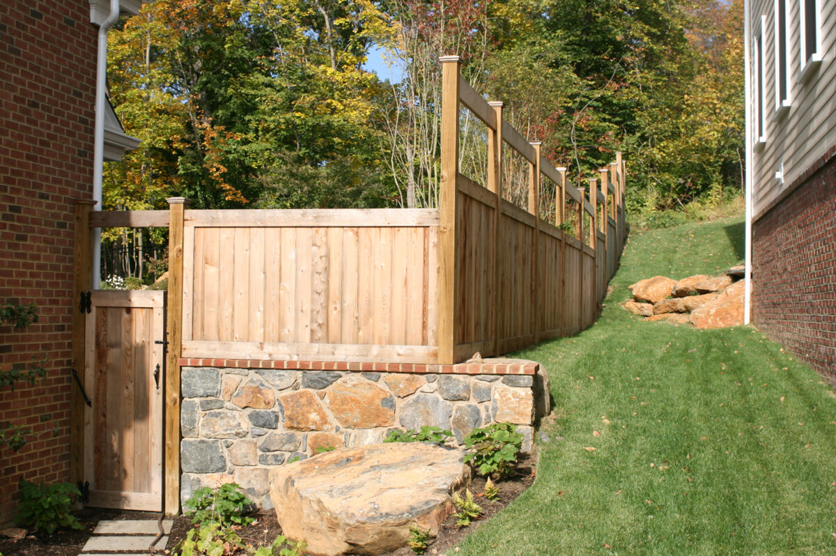 wooden fence with small gate on to pof wall