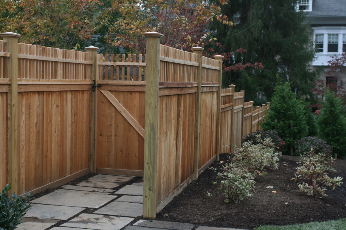 wooden privacy fence with decorative spindle top and walk gate