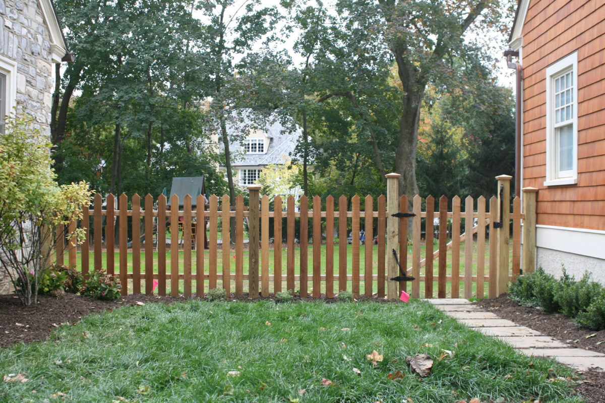 wood picket fence with post caps and self closing gate