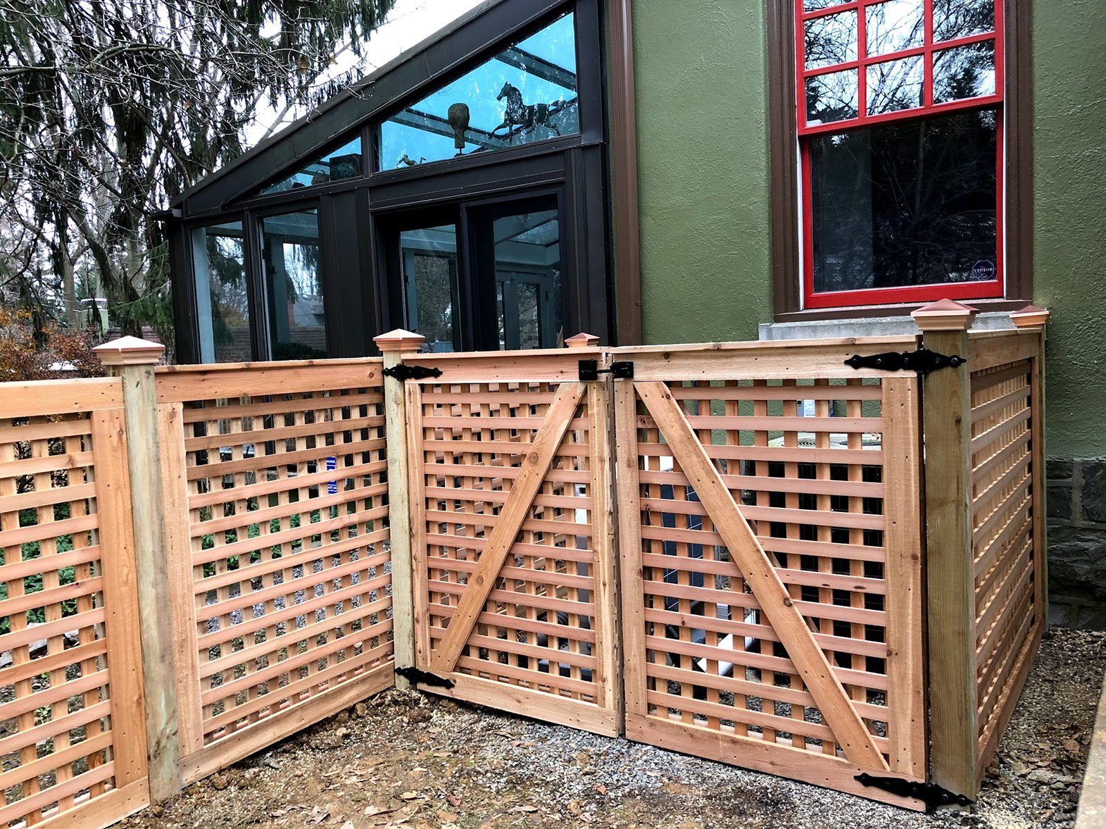 Framed red cedar fence in yard with gates
