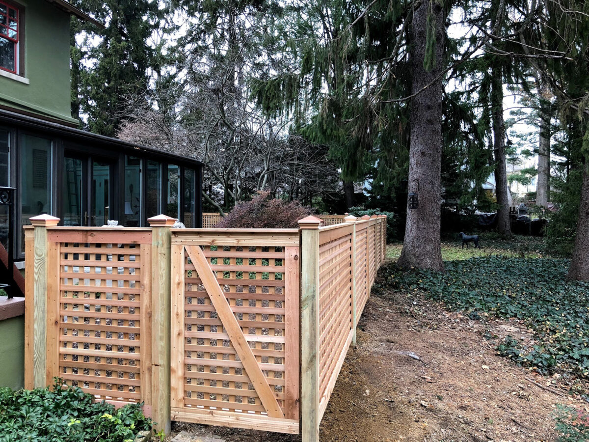 Framed red cedar fence in yard with gates