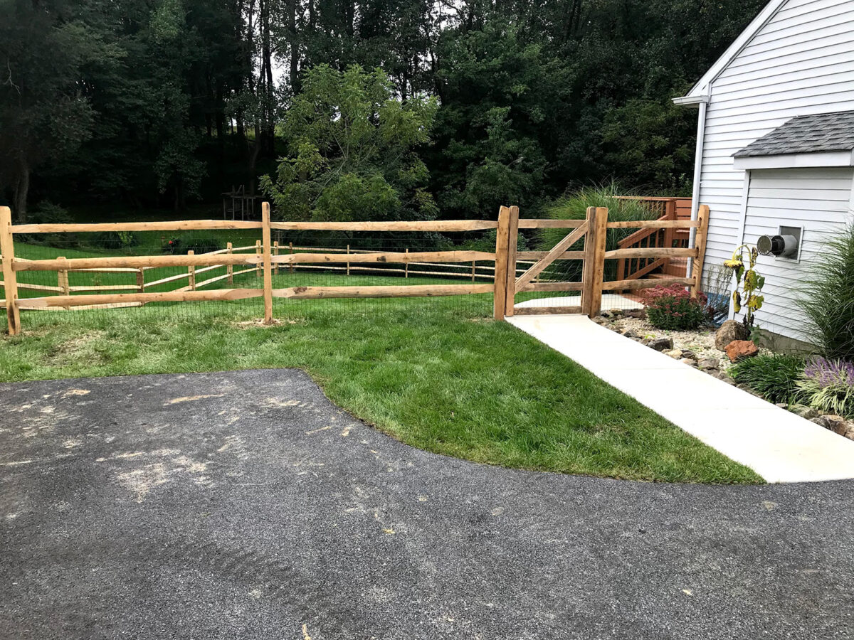 split rail fence with gate in yard