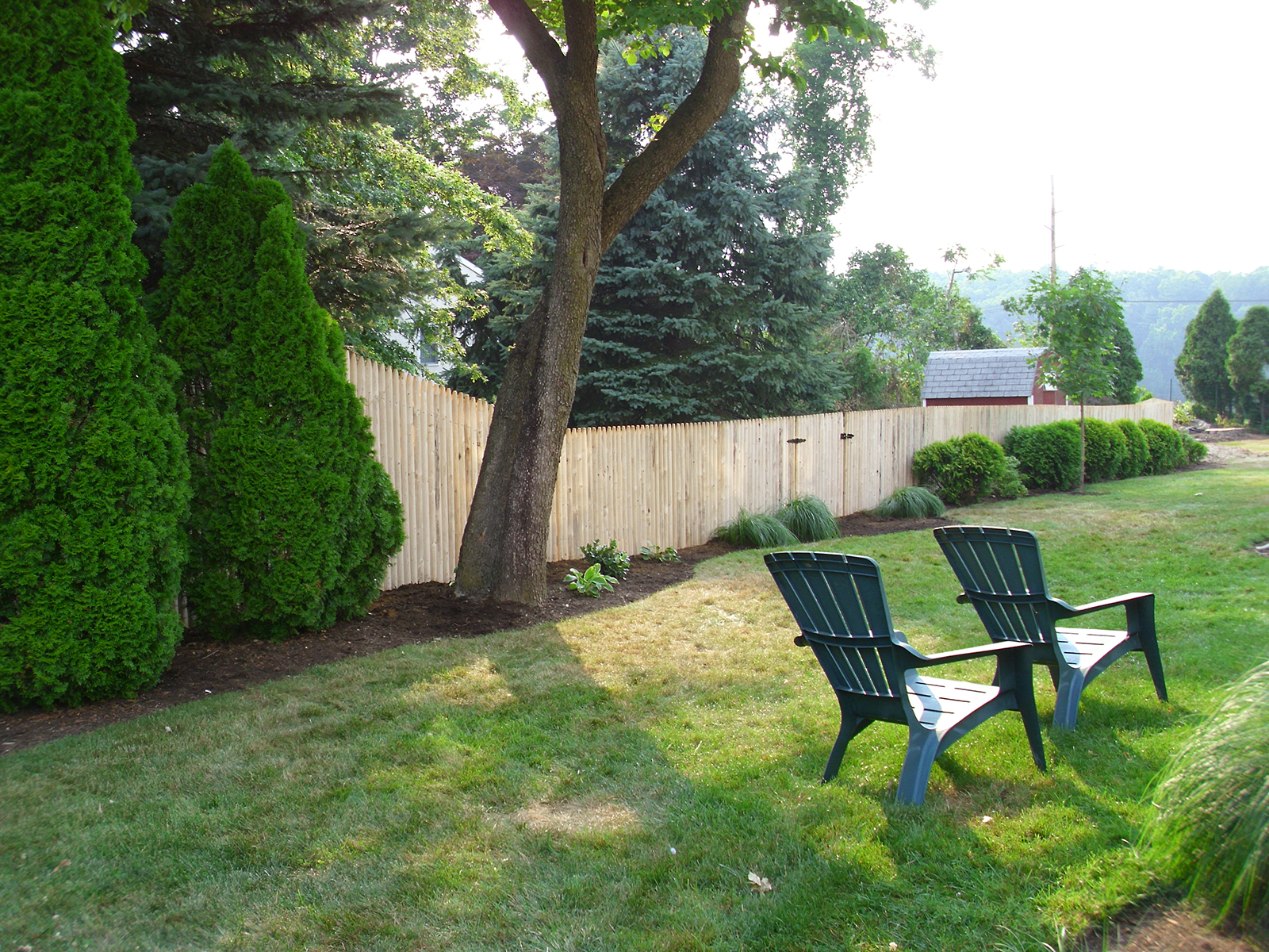 Stockade fence in yard with gate