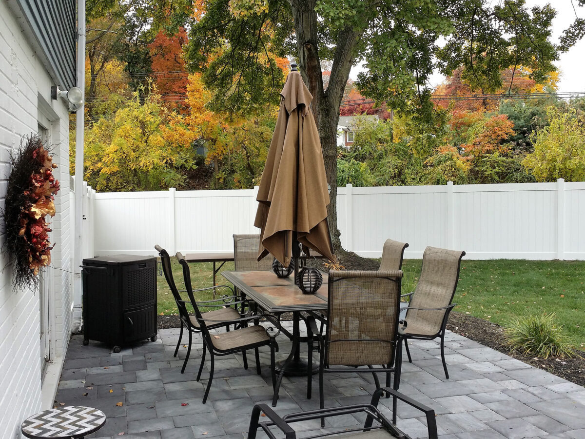 white privacy fence in yard with picnic table