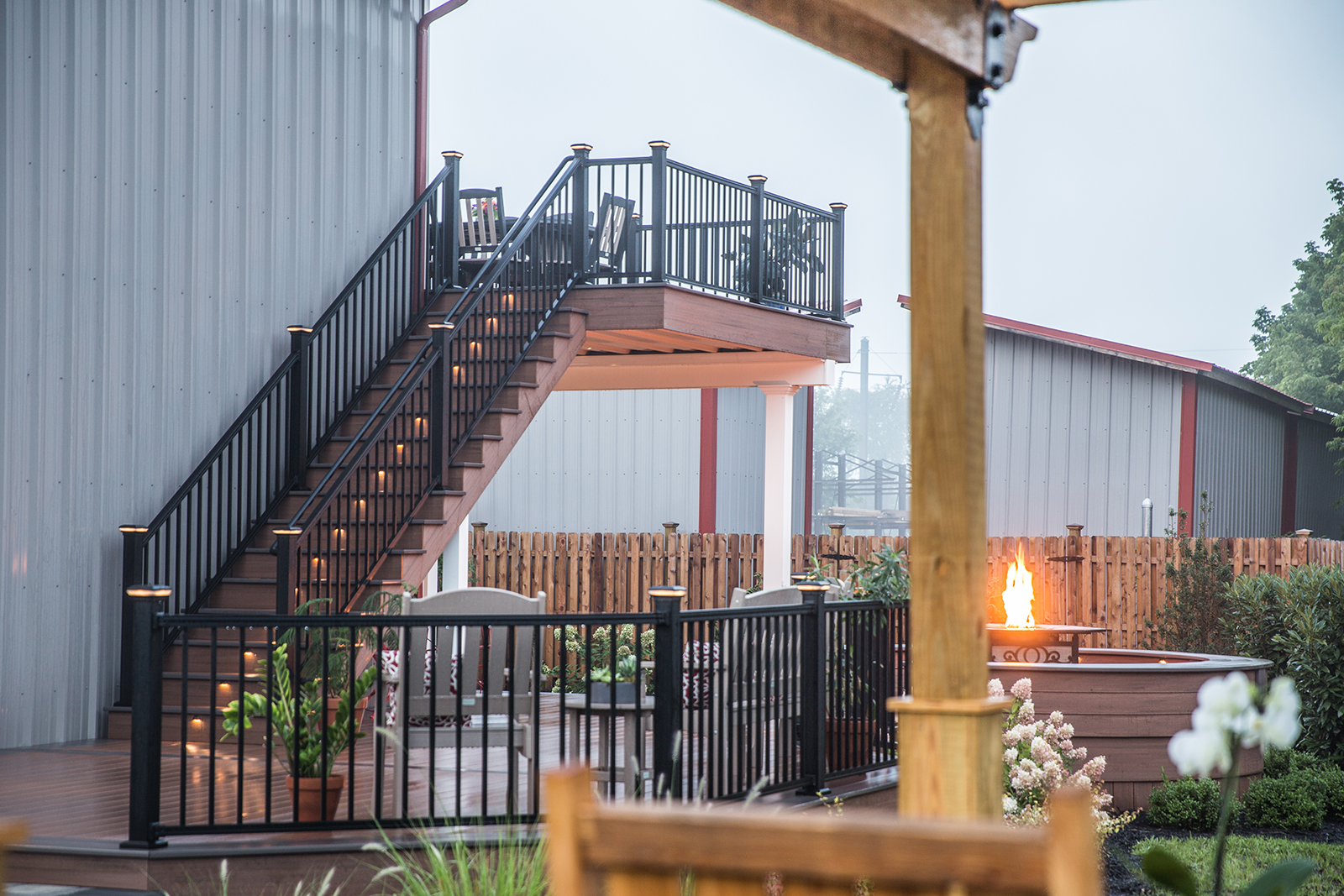 lighted stairs on deck with fireplace