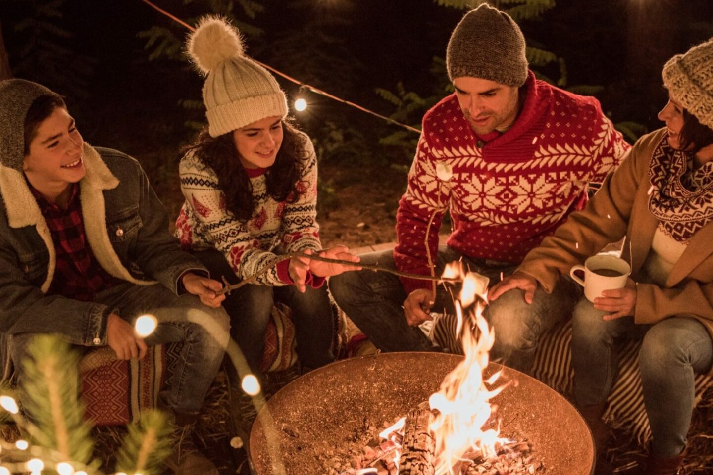 Family enjoying an outdoor fire pit in the winter