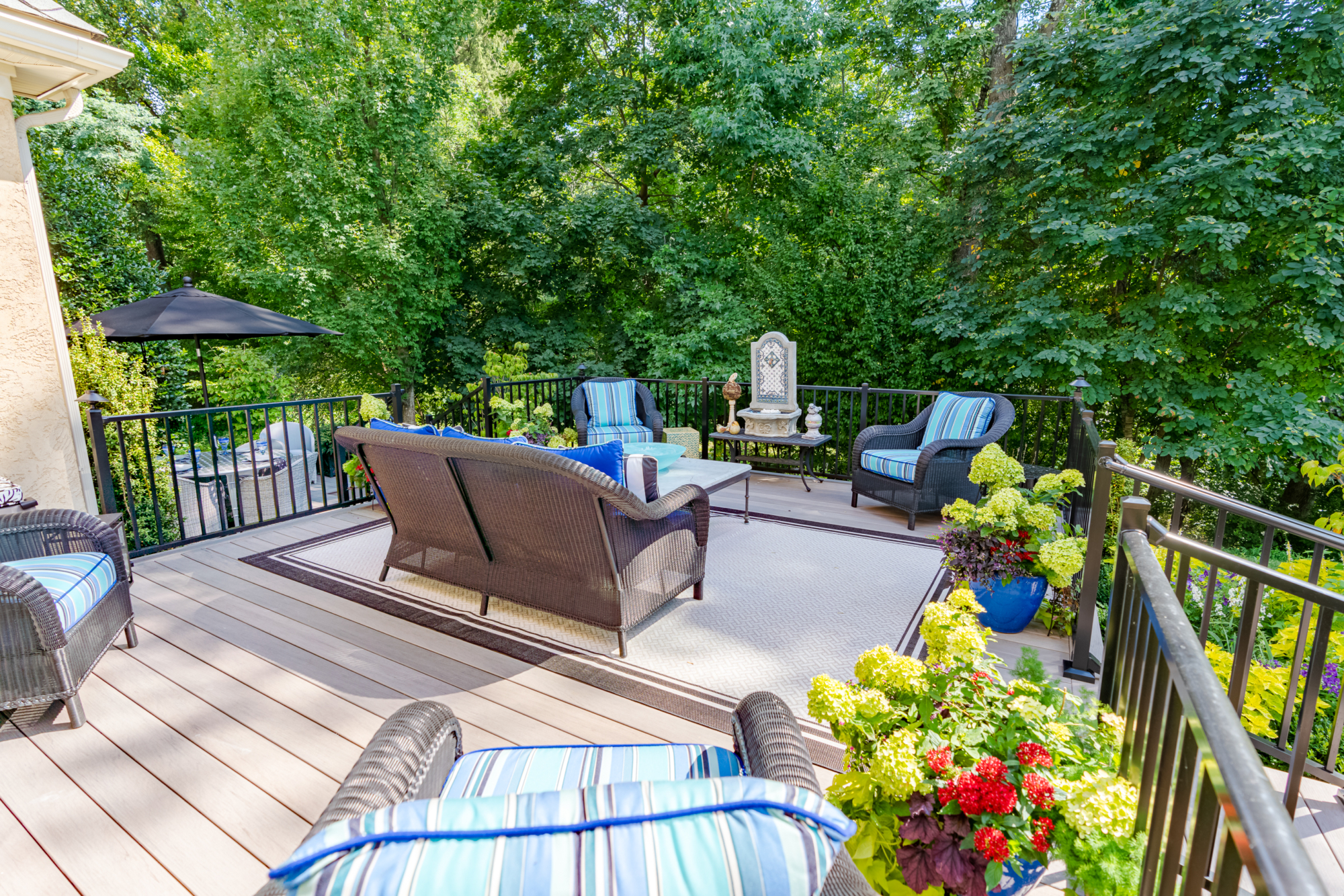 image of a deck with westbury black aluminum railing and timbertech ashwood decking built by integrous fences and decks