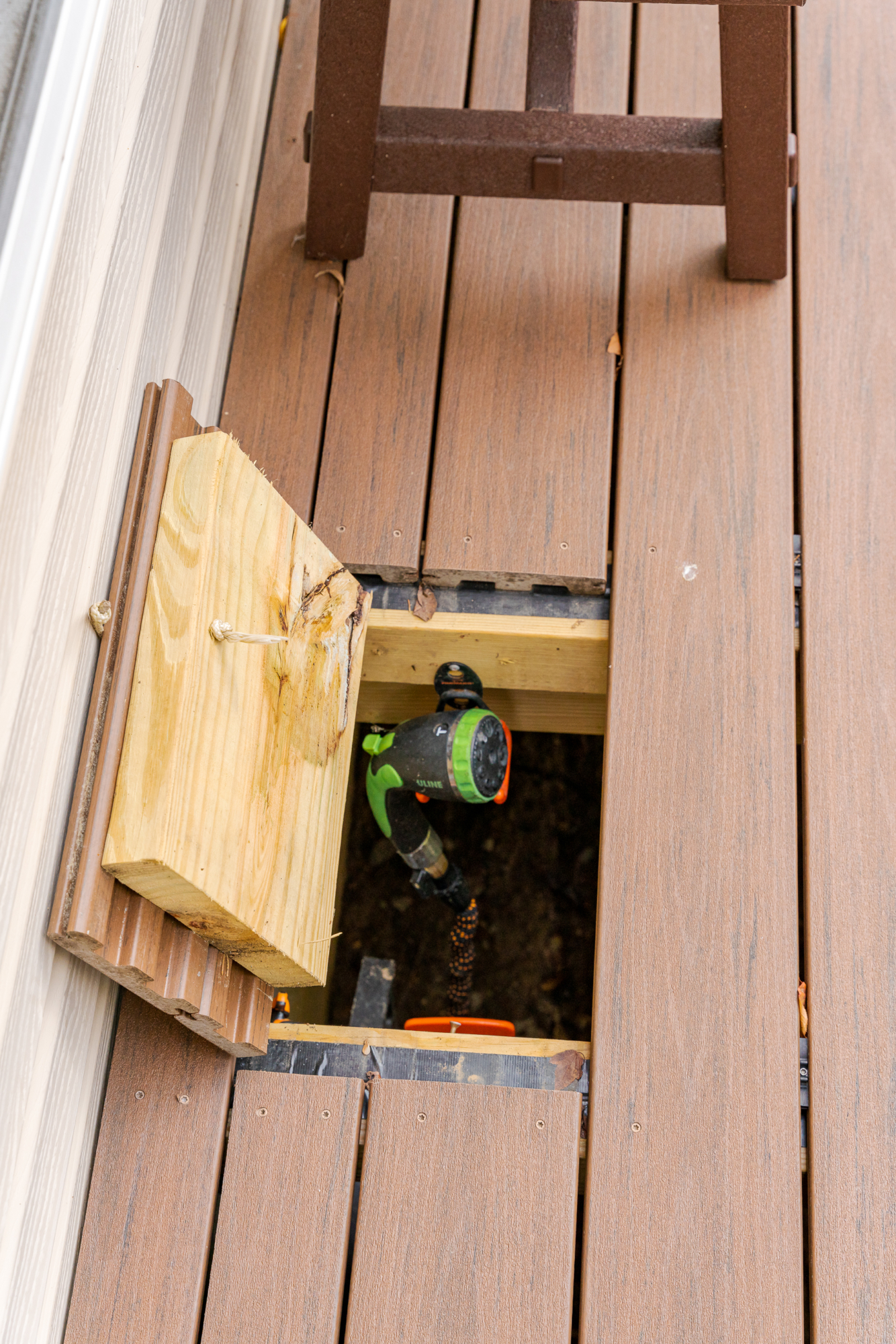 image of a deck with lattice skirting in media pa built by integrous fences and decks featuring timbertech decking white vinyl railing, and white vinyl underdeck lattice skirting with two steps to grade
