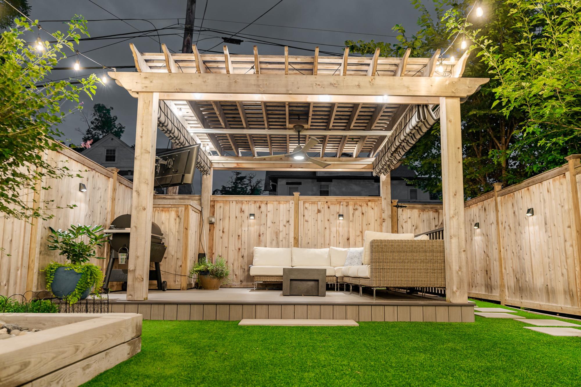 image of a backyard in lancaster city pa built by integrous fences and decks featuring two cedar pergolas multiple decks and beautifully designed landscaping