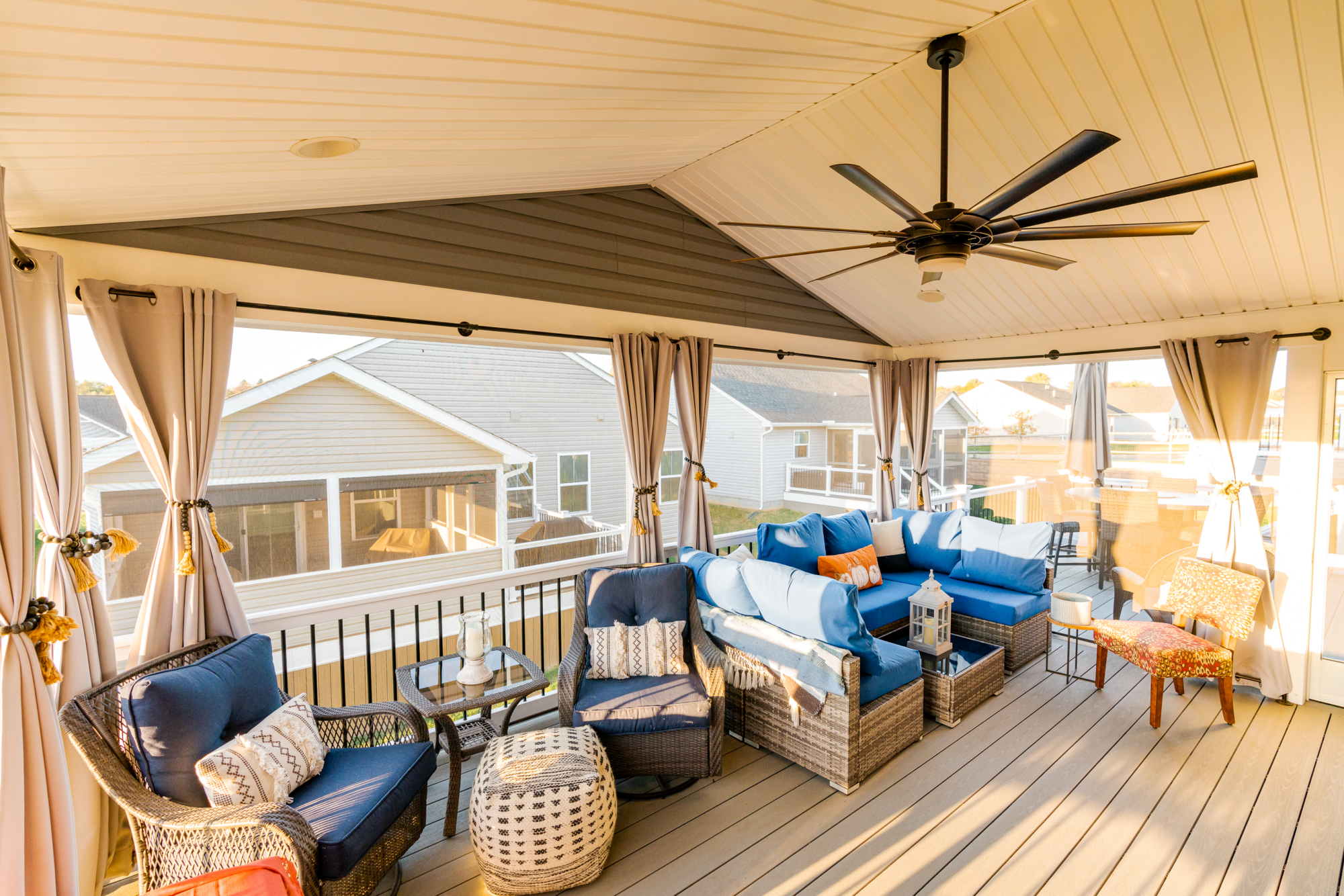 image of a deck with a screened in roof in coatesville pa built by integrous fences and decks featuring a screened in roof area an open deck timbertech decking white vinyl railing with black aluminum balusters and one set of stairs to grade