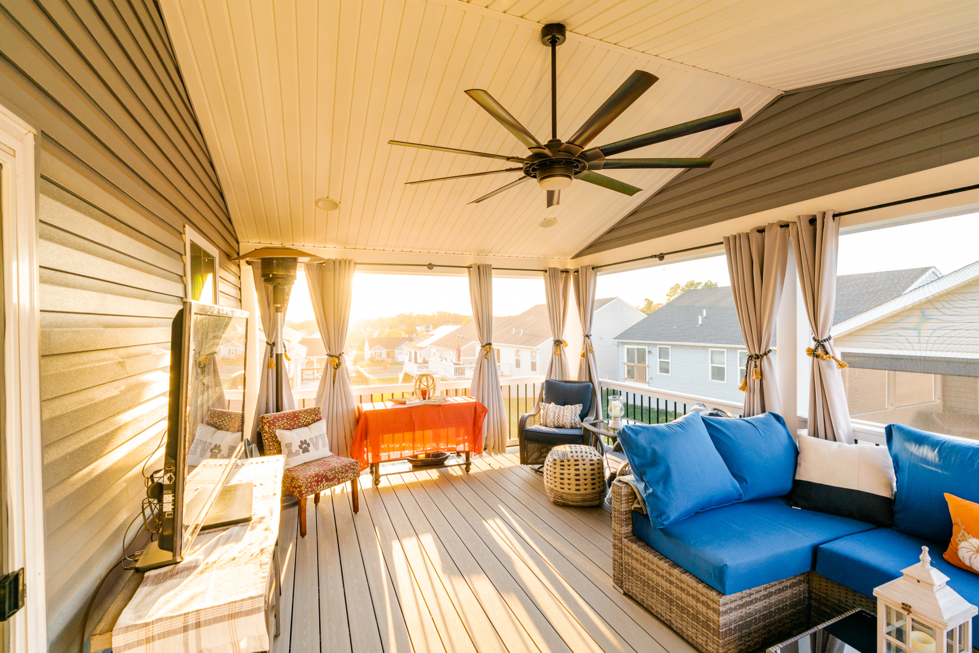 image of a deck with a screened in roof in coatesville pa built by integrous fences and decks featuring a screened in roof area an open deck timbertech decking white vinyl railing with black aluminum balusters and one set of stairs to grade