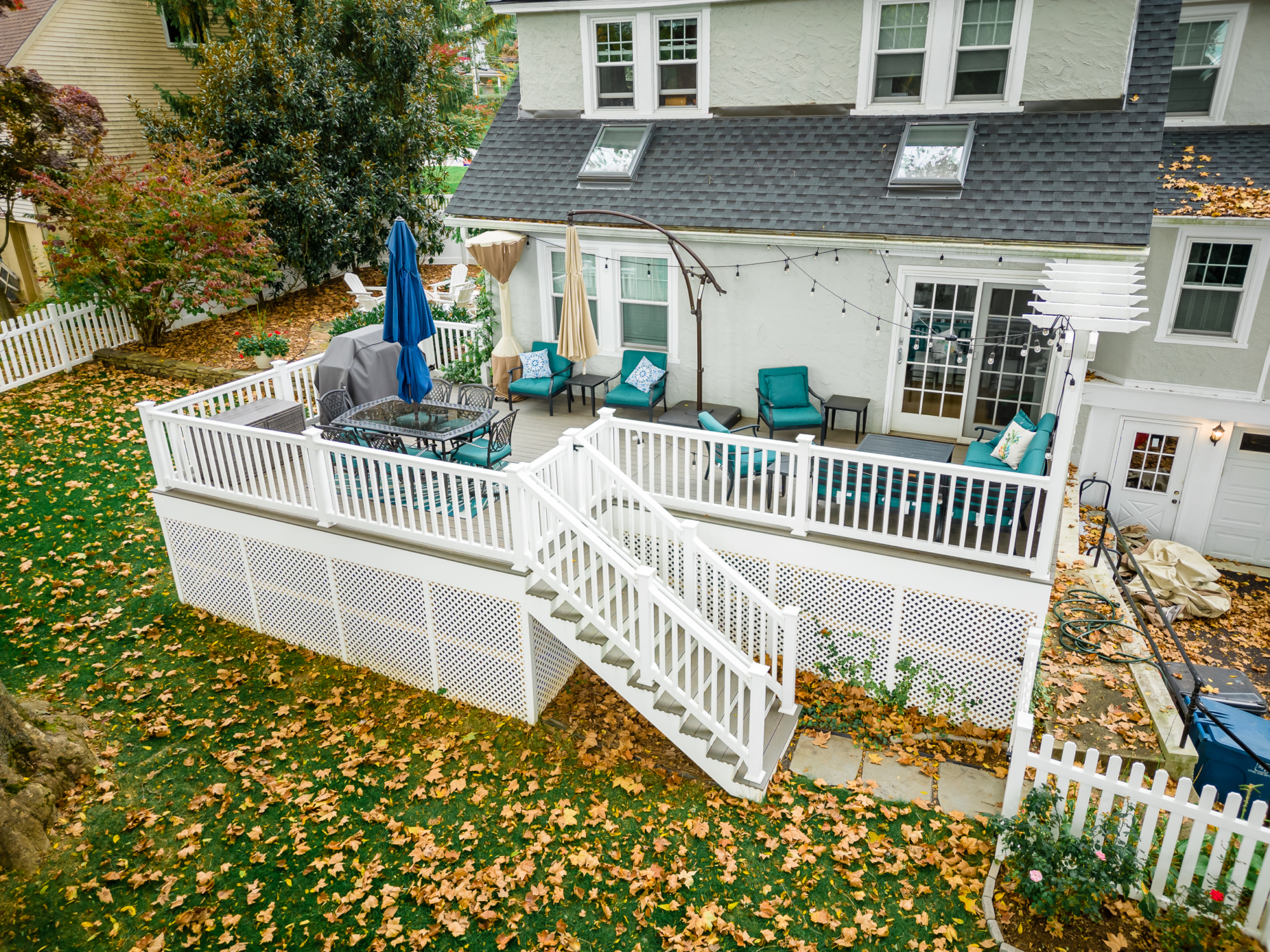 image of a deck in paoli pa built by integrous fences and decks featuring timbertech decking lattice skirting and privacy wall and white vinyl railing