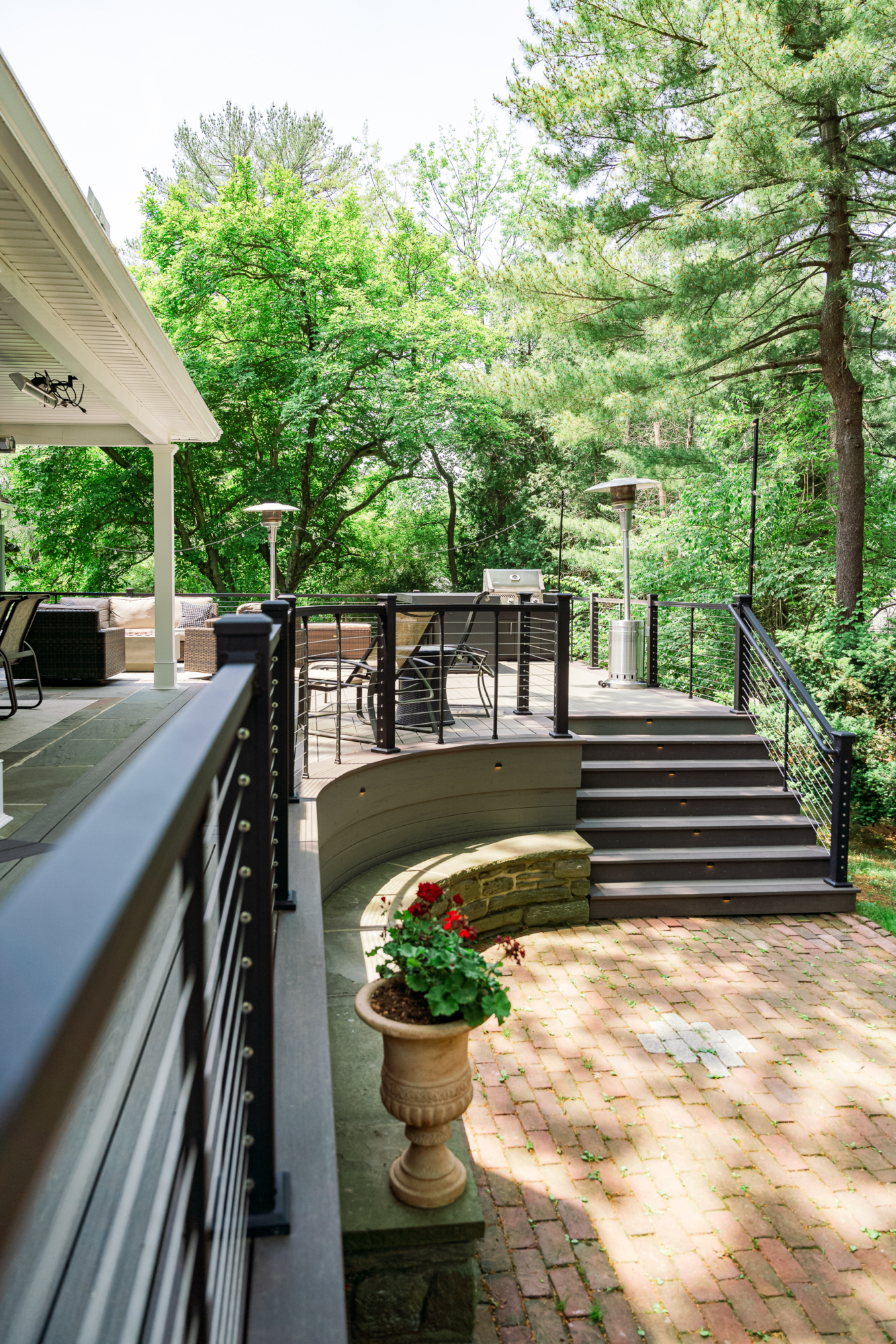 image of a large open deck in gladwyne pa built by integrous fences and decks featuring timbertech decking keylink cable railing and color matching fascia