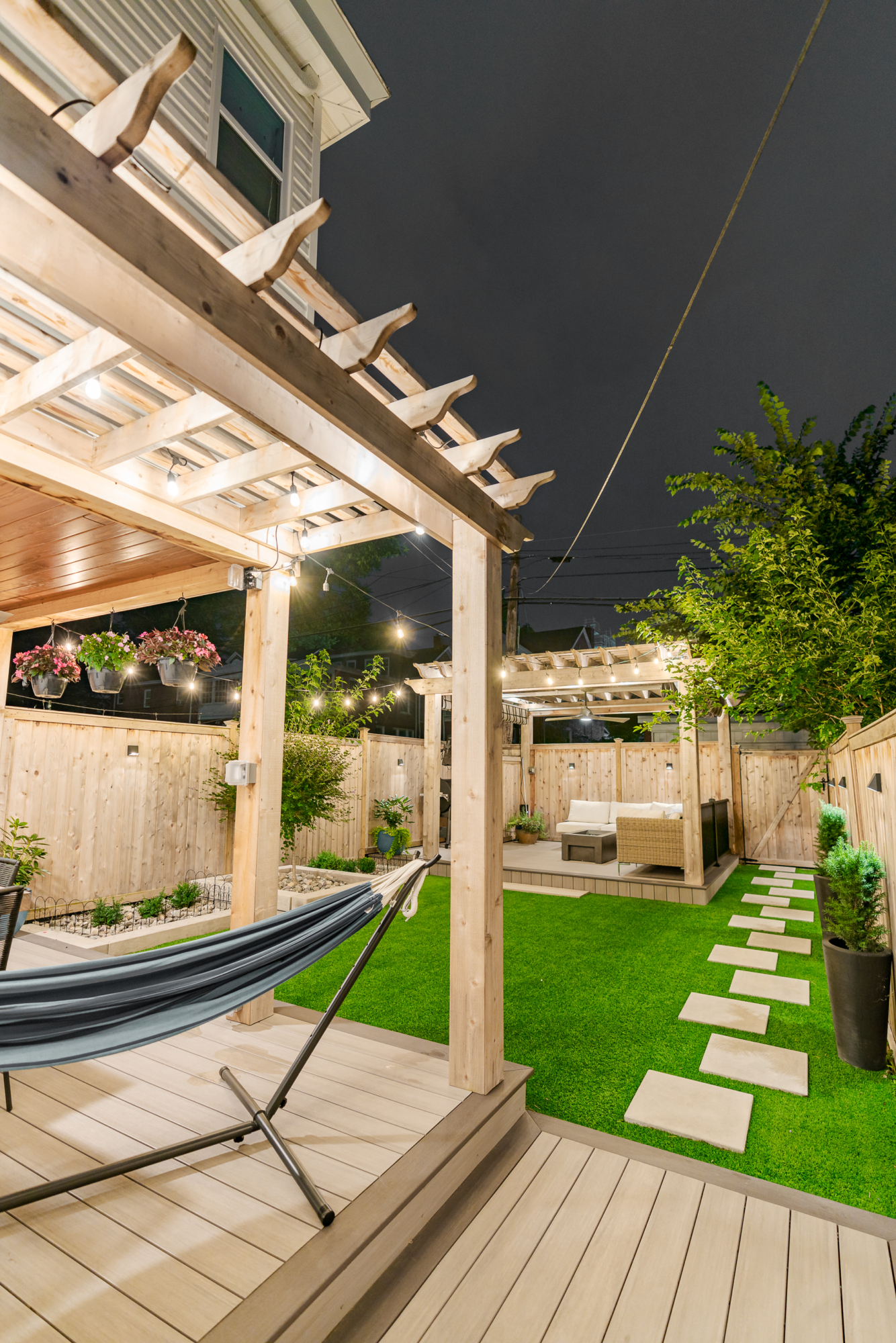 image of a backyard in lancaster city pa built by integrous fences and decks featuring two cedar pergolas multiple decks and beautifully designed landscaping