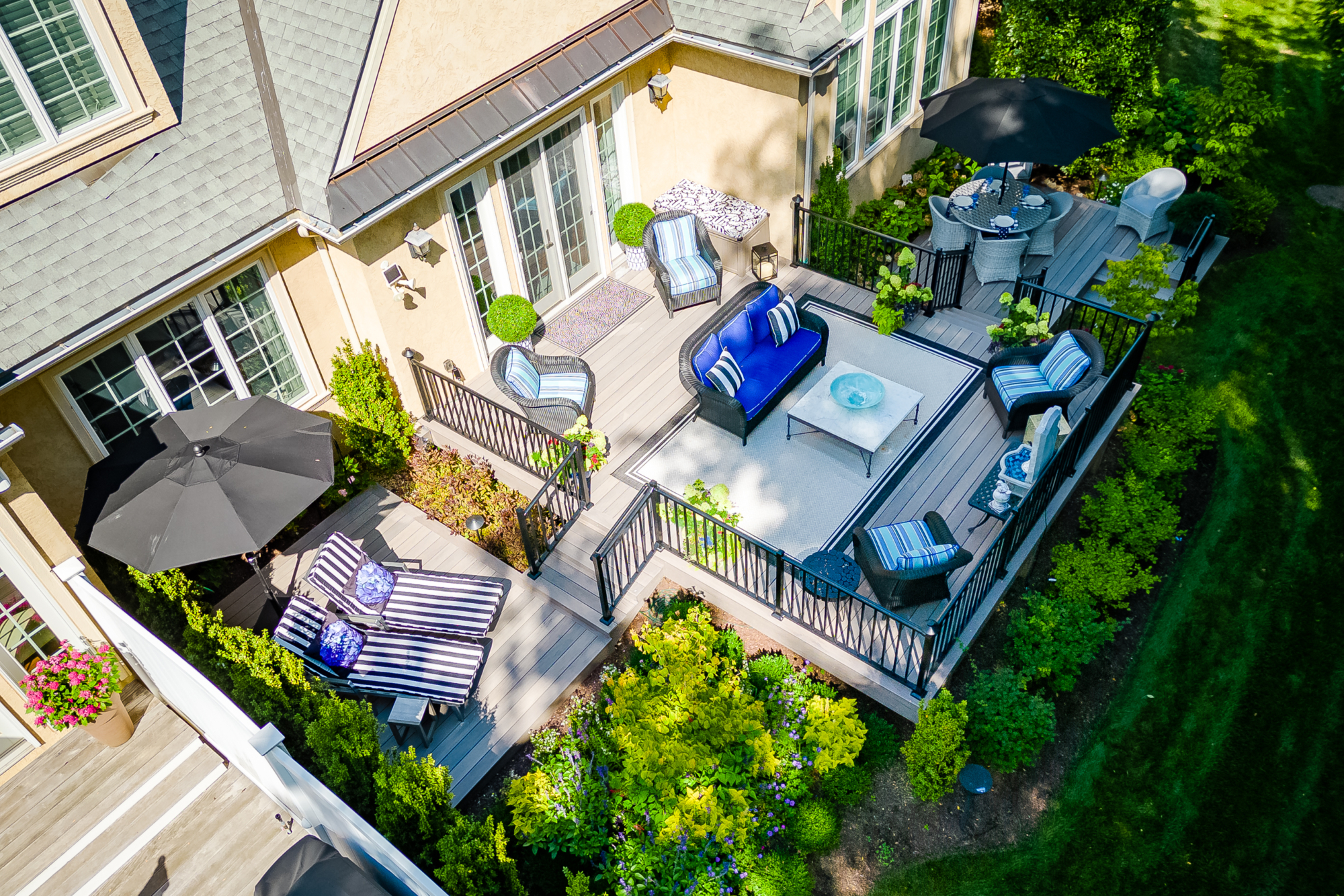 image of a multilevel deck in a beautifully designed backyard built by integrous fences and decks