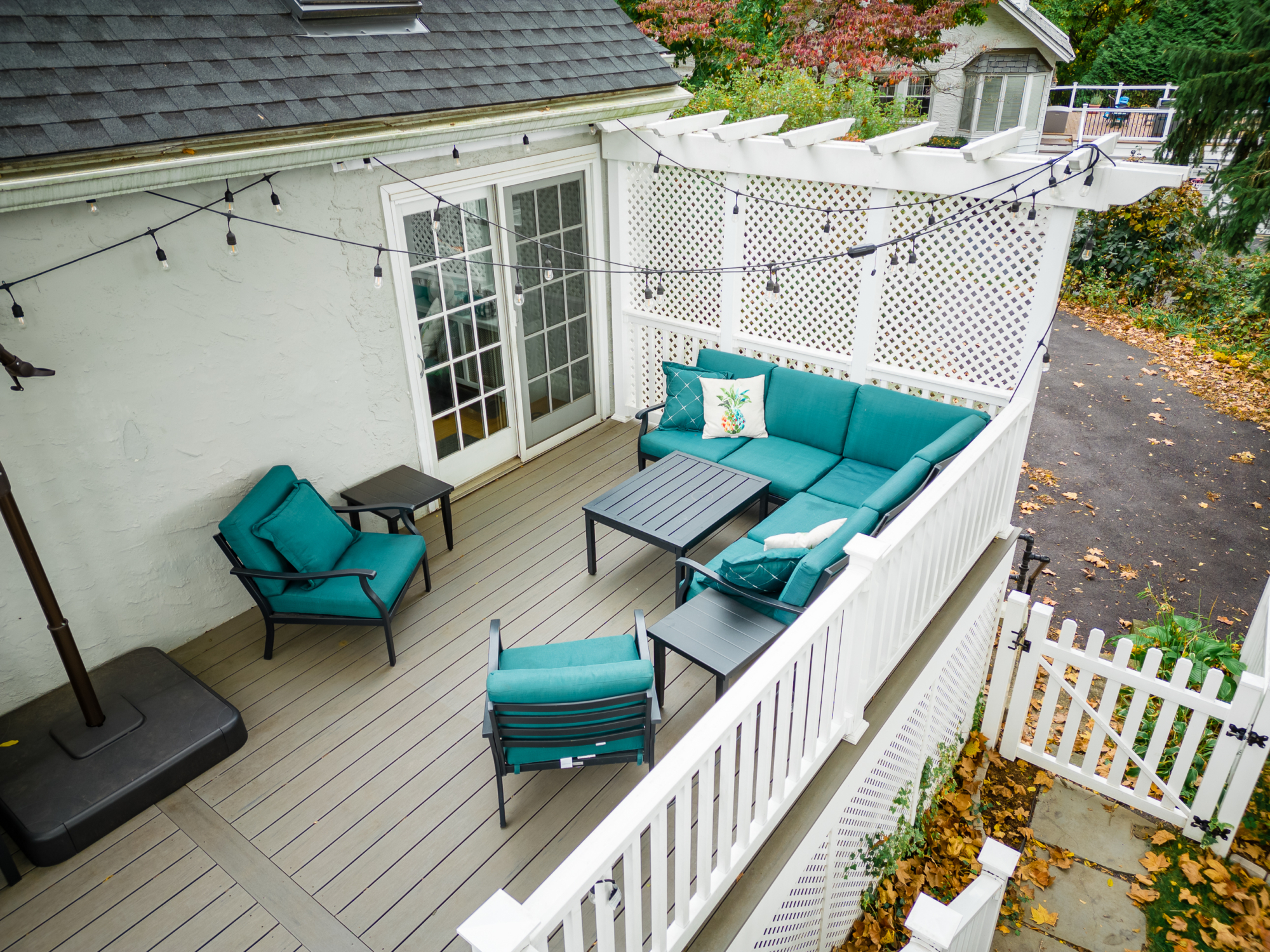 image of a deck in paoli pa built by integrous fences and decks featuring timbertech decking lattice skirting and privacy wall and white vinyl railing