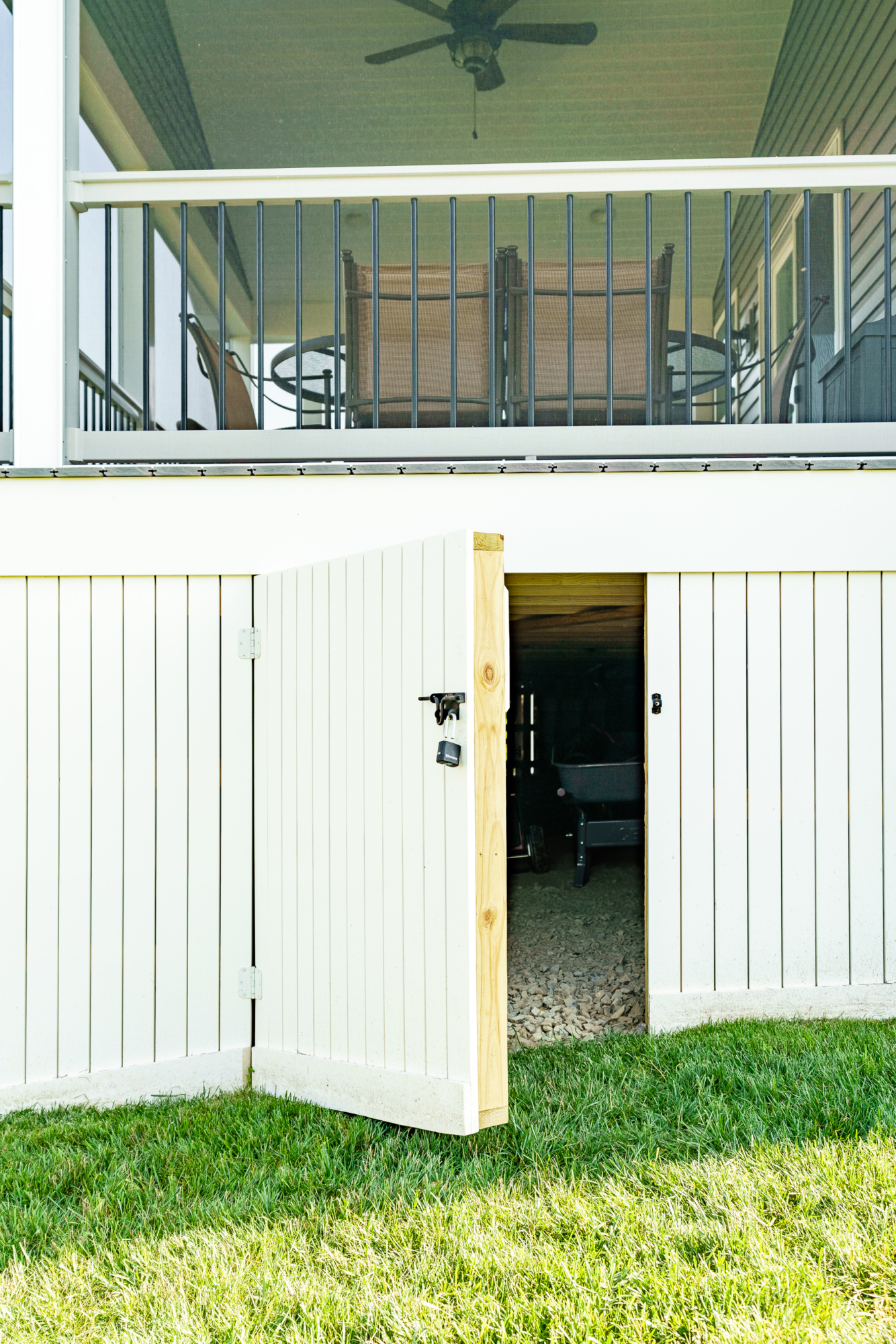 image of vynl deck skirting with an open door creating a underdeck storage area built by integrous fences and decks