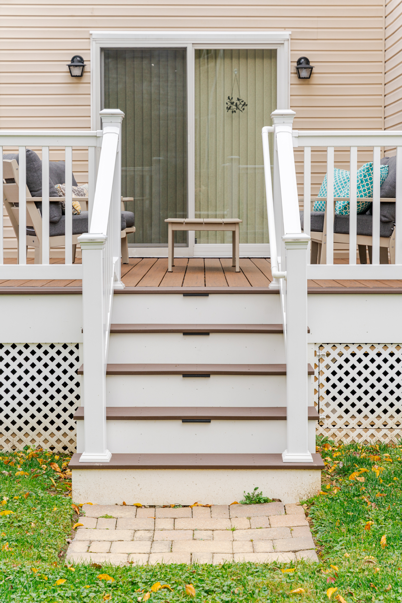 image of a deck with lattice skirting in media pa built by integrous fences and decks featuring timbertech decking white vinyl railing, and white vinyl underdeck lattice skirting with two steps to grade