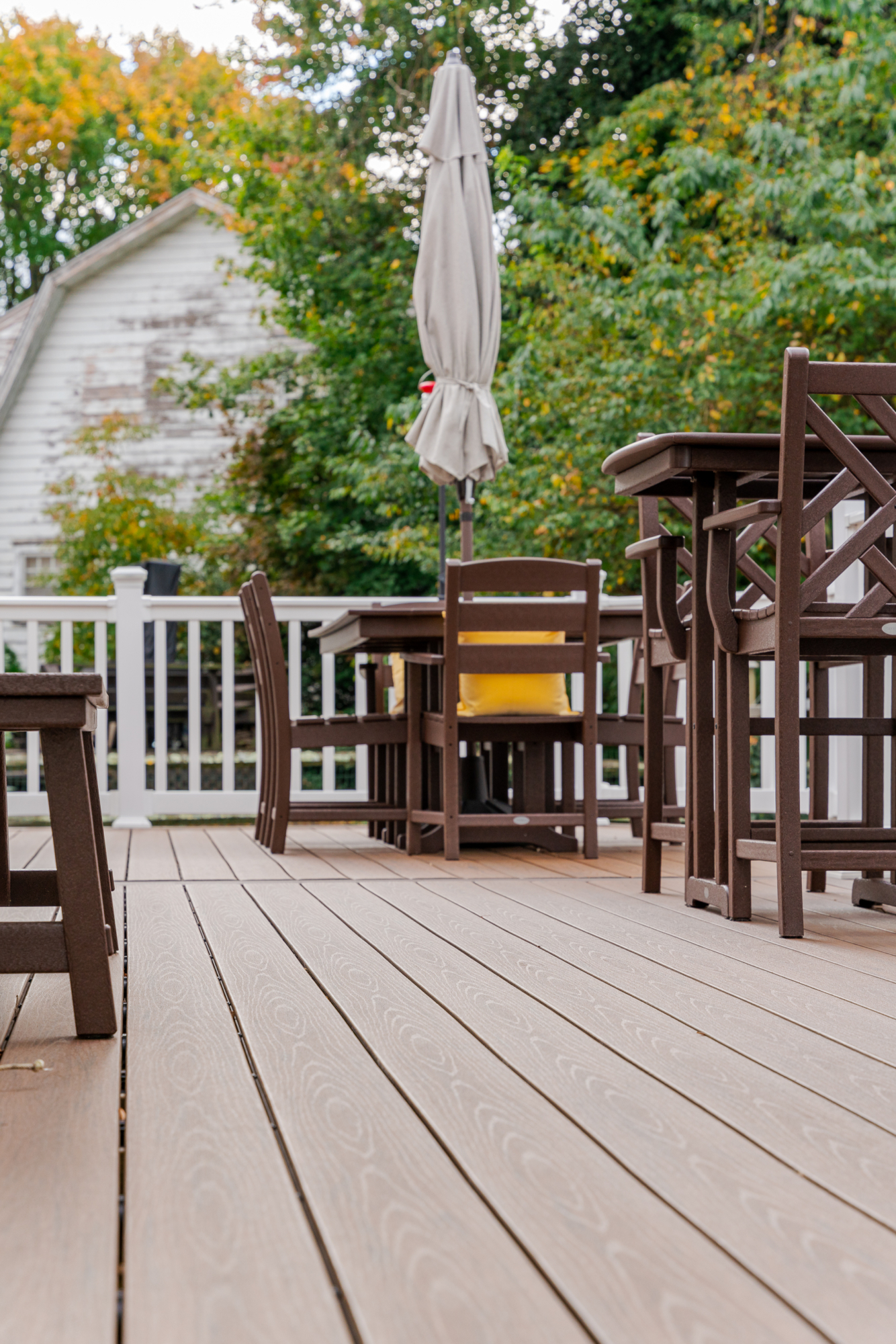 image of a deck with lattice skirting in media pa built by integrous fences and decks featuring timbertech decking white vinyl railing, and white vinyl underdeck lattice skirting with two steps to grade