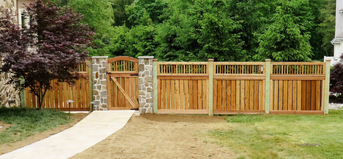 Custom spaced 1x6 wood fence with spindle top & caps